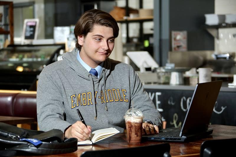 Aidan studying in a coffee shop.